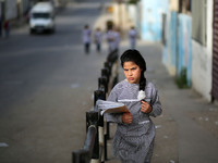 Palestinian students walk on their way to school to attend their end-of-year exams in Gaza City on May 23, 2019. (