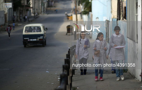 Palestinian students walk on their way to school to attend their end-of-year exams in Gaza City on May 23, 2019. 