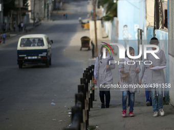 Palestinian students walk on their way to school to attend their end-of-year exams in Gaza City on May 23, 2019. (