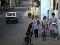 Palestinian students walk on their way to school to attend their end-of-year exams in Gaza City on May 23, 2019. (