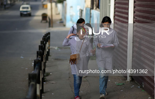 Palestinian students walk on their way to school to attend their end-of-year exams in Gaza City on May 23, 2019. 