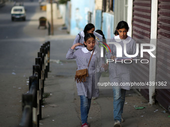 Palestinian students walk on their way to school to attend their end-of-year exams in Gaza City on May 23, 2019. (