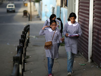 Palestinian students walk on their way to school to attend their end-of-year exams in Gaza City on May 23, 2019. (