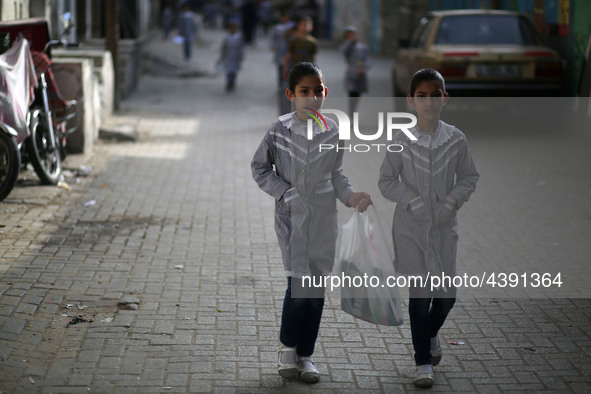 Palestinian students walk on their way to school to attend their end-of-year exams in Gaza City on May 23, 2019. 