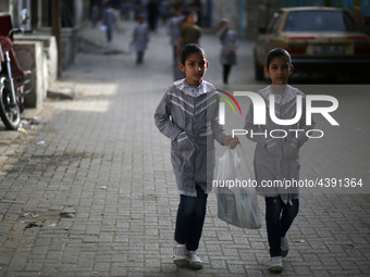 Palestinian students walk on their way to school to attend their end-of-year exams in Gaza City on May 23, 2019. (