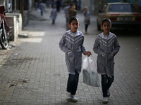 Palestinian students walk on their way to school to attend their end-of-year exams in Gaza City on May 23, 2019. (