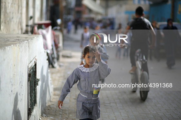 Palestinian students walk on their way to school to attend their end-of-year exams in Gaza City on May 23, 2019. 