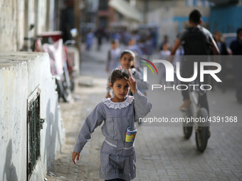 Palestinian students walk on their way to school to attend their end-of-year exams in Gaza City on May 23, 2019. (