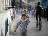 Palestinian students walk on their way to school to attend their end-of-year exams in Gaza City on May 23, 2019. (