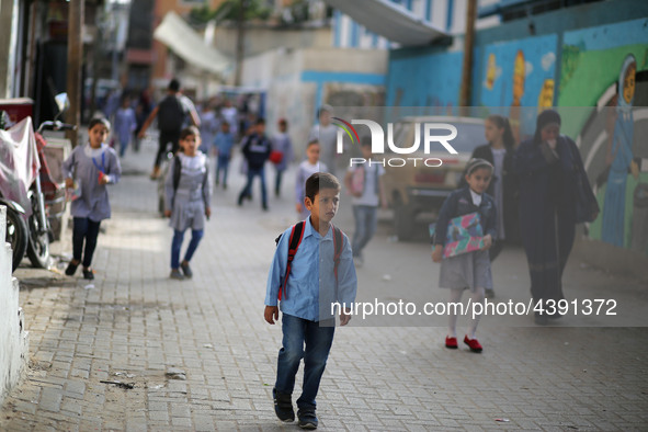 Palestinian students walk on their way to school to attend their end-of-year exams in Gaza City on May 23, 2019. 