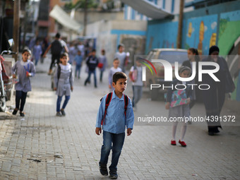 Palestinian students walk on their way to school to attend their end-of-year exams in Gaza City on May 23, 2019. (