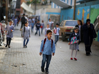 Palestinian students walk on their way to school to attend their end-of-year exams in Gaza City on May 23, 2019. (