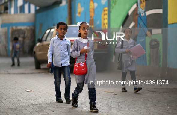 Palestinian students walk on their way to school to attend their end-of-year exams in Gaza City on May 23, 2019. 