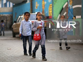 Palestinian students walk on their way to school to attend their end-of-year exams in Gaza City on May 23, 2019. (