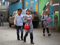 Palestinian students walk on their way to school to attend their end-of-year exams in Gaza City on May 23, 2019. (