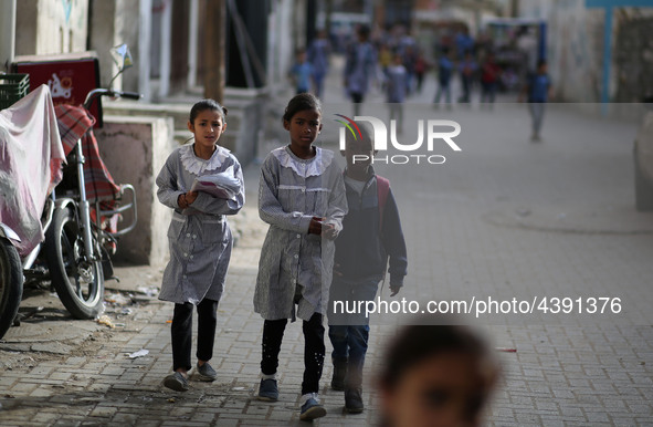 Palestinian students walk on their way to school to attend their end-of-year exams in Gaza City on May 23, 2019. 