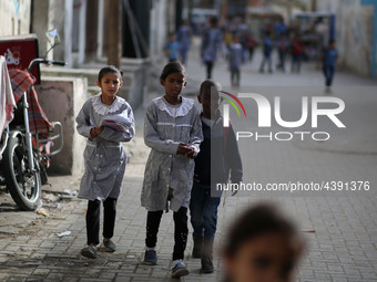 Palestinian students walk on their way to school to attend their end-of-year exams in Gaza City on May 23, 2019. (