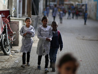 Palestinian students walk on their way to school to attend their end-of-year exams in Gaza City on May 23, 2019. (