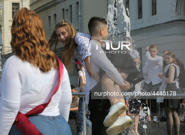 Ukrainian youth celebrates their graduation off the middle school 
with fooling in the fountains at Independence Square in Kyiv,  Ukraine,...