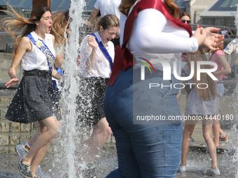 Ukrainian youth celebrates their graduation off the middle school 
with fooling in the fountains at Independence Square in Kyiv,  Ukraine,...