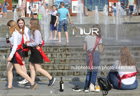 Ukrainian youth celebrates their graduation off the middle school 
with fooling in the fountains at Independence Square in Kyiv,  Ukraine,...