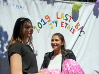 Two highschool students pose in front of a sheet reading '2019 Last Baccalaureate: I was there'. Some high school teachers were on strike ag...