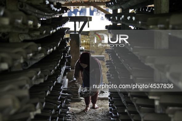 Female workers work on making tiles in clay tile factories at Pakuncen sub-district, Banyumas regency, Central Java province, on June 16, 20...