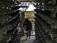 Female workers work on making tiles in clay tile factories at Pakuncen sub-district, Banyumas regency, Central Java province, on June 16, 20...