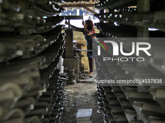 Female workers work on making tiles in clay tile factories at Pakuncen sub-district, Banyumas regency, Central Java province, on June 16, 20...