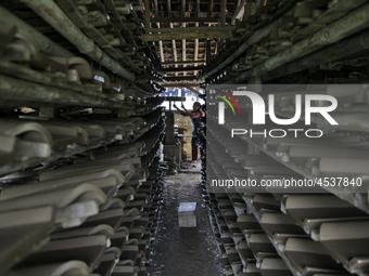 Female workers work on making tiles in clay tile factories at Pakuncen sub-district, Banyumas regency, Central Java province, on June 16, 20...