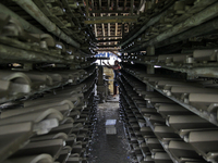 Female workers work on making tiles in clay tile factories at Pakuncen sub-district, Banyumas regency, Central Java province, on June 16, 20...