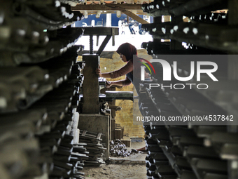 Female workers work on making tiles in clay tile factories at Pakuncen sub-district, Banyumas regency, Central Java province, on June 16, 20...