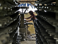 Female workers work on making tiles in clay tile factories at Pakuncen sub-district, Banyumas regency, Central Java province, on June 16, 20...