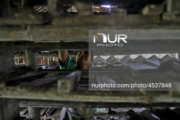 Female workers work on making tiles in clay tile factories at Pakuncen sub-district, Banyumas regency, Central Java province, on June 16, 20...