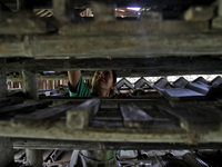 Female workers work on making tiles in clay tile factories at Pakuncen sub-district, Banyumas regency, Central Java province, on June 16, 20...