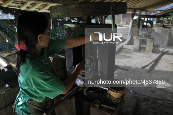 Female workers work on making tiles in clay tile factories at Pakuncen sub-district, Banyumas regency, Central Java province, on June 16, 20...