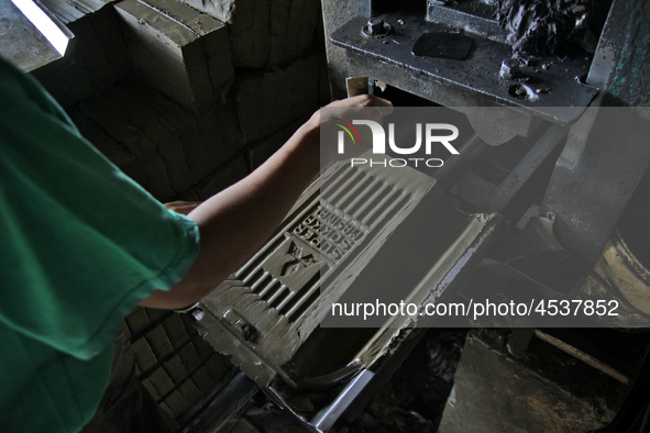 Female workers work on making tiles in clay tile factories at Pakuncen sub-district, Banyumas regency, Central Java province, on June 16, 20...