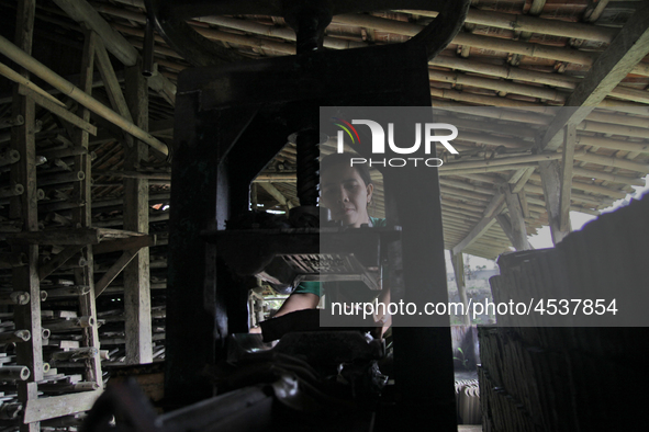 Female workers work on making tiles in clay tile factories at Pakuncen sub-district, Banyumas regency, Central Java province, on June 16, 20...