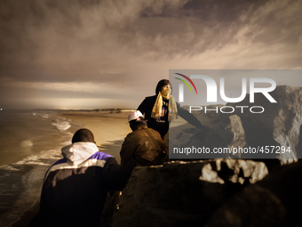 After climbing through a wall of rocks separating the beach from the port, a group of migrants attempt smuggling themselves into the port's...