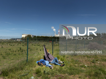 Migrants sleep in a field after spending the night attempting to jump inside trucks that will be taken to Dover in the next Ferri. Calais, F...