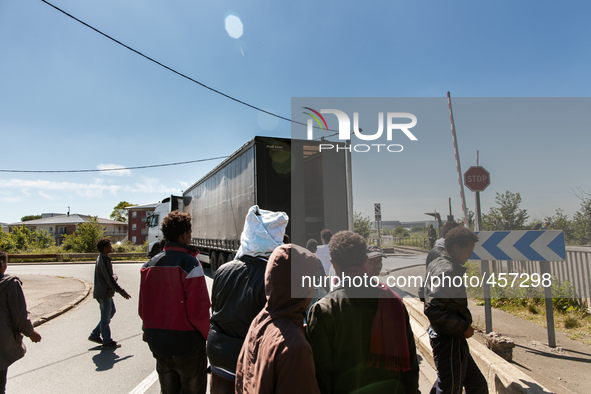 Migrants give up trying to jump inside a moving truck when they realise the vehicle is not heading towards the ferri port.  These attempts a...