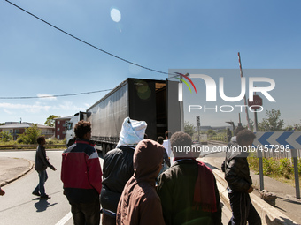 Migrants give up trying to jump inside a moving truck when they realise the vehicle is not heading towards the ferri port.  These attempts a...