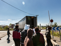 Migrants give up trying to jump inside a moving truck when they realise the vehicle is not heading towards the ferri port.  These attempts a...