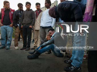 A migrants is assisted by his colleagues after reporting a police attack near the port. Calais, France, June 2014.

For the last 20 years...