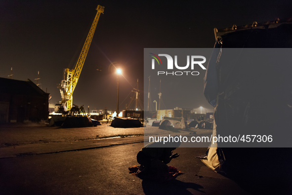 A migrant is seen praying after the sun has set. Calais, France, June 2014.

For the last 20 years the French city of Calais, with links f...