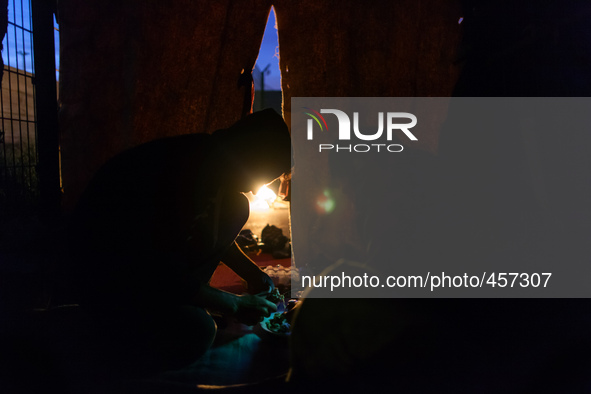 A migrant prepares dinner made of very basic ingredients.. Calais, France, June 2014.

For the last 20 years the French city of Calais, wi...