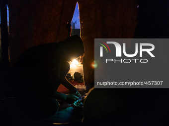 A migrant prepares dinner made of very basic ingredients.. Calais, France, June 2014.

For the last 20 years the French city of Calais, wi...