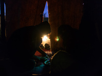 A migrant prepares dinner made of very basic ingredients.. Calais, France, June 2014.

For the last 20 years the French city of Calais, wi...