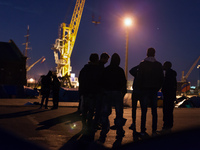 Migrants discuss in the camp at night. Calais, France, June 2014.

For the last 20 years the French city of Calais, with links from the Eu...