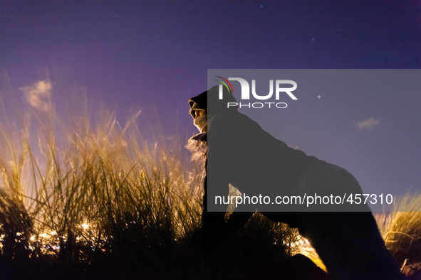 A migrant looks out for police presence near the port from behind some bushes. Calais, France, June 2014.

For the last 20 years the Frenc...